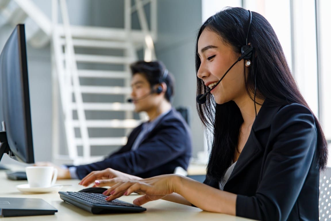 Asian happy female telemarketer receptionist operator service su